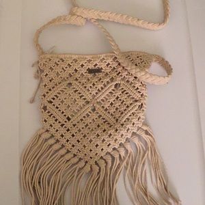 Cream colored Ripcurl cross body bag with tassels